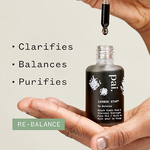 Image 1 - A hand holding a dropper bottle labeled Païl CARBON STAR™ Re-Balance Black Cumin Seed & Charcoal Overnight Face Oil with the words Clarifies, Balances, and Purifies displayed beside it, and a green rectangle below reading RE-BALANCE.
Image 2 - An image of a dropper bottle with a dark serum and a drop of serum on a white surface, featuring the text 76% said skin looked clearer and logos for Soil Association, Cosmos Natural, Vegan, and Certified B Corporation, along with a note about a 4 week independent user trial on 49 subjects.