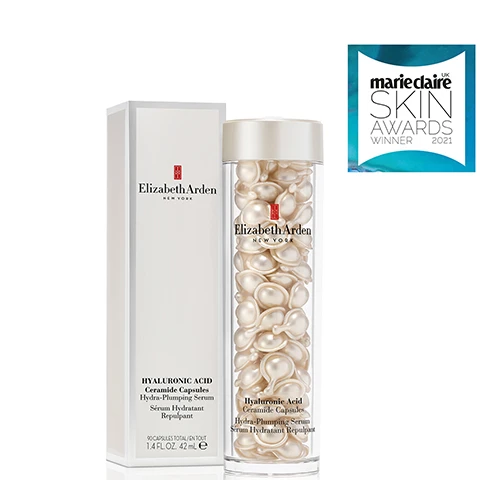 Image 1 - A bottle of Elizabeth Ardens Hyaluronic Acid Ceramide Capsules with a white box, and a sticker in the top right corner that says marieclaire SKIN AWARDS WINNER 2021.
Image 2 - An overhead view of a white cream in a circular container against a light blue background, with the text Silky Smooth, Lightweight Serum.
Image 3 - A clear container holding white capsules is shown against a bright blue background; the visible text reads PURE Benefit-rich ingredients, POTENT Freshness-sealed to protect from light and air, and PRECISE Premeasured, single-dose treatments.
Image 4 - A woman holding a small pearl-like skincare product near her face is smiling against a soft blue background, with the text Plump & Hydrate and 98% see plumper skin* displayed prominently.
Image 5 - A close-up image of a hand holding a small, clear gel capsule, with text that reads Twist, Squeeze, Smooth, a sun icon, and instructions that say HOW TO USE: Apply on Face, Neck and Décolleté.
Image 6 - A group of skincare serum capsules in clear containers, featuring various colors and sizes, with the text Pure. Potent. Precise. Discover Ceramide Capsule Serums for Every Skin Concern displayed in a stylish font above.
