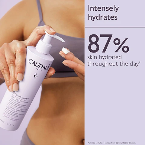 Image 1 - A person is holding a bottle of Caudalie moisturizer and applying a small amount to their hand, with a text section stating Intensely hydrates and 87% skin hydrated throughout the day.
Image 2 - A white bottle of Caudalie Vinotherapist body cream with a purple background, featuring the text Hyaluronic Acid, Shea Butter, and Polyphenols, along with descriptions of their benefits: Hyaluronic Acid smooths and hydrates the surface of the skin, Shea Butter nourishes, regenerates, and repairs, and Polyphenols are antioxidants.
Image 3 - Image shows five skincare products arranged on a light purple background, labeled with steps for use: step 1 is Hyaluronic Nourishing Body Lotion, step 2 is Hand & Nail Repairing Cream, and step 3 is Foot Beauty Cream, with a visible white cream swirling on one product.
Image 4 - Image shows three bottles of Caudalie Vinotherapist Body Lotion with an elegant floral background and instructions on how to recycle, stating How to recycle the Vinotherapist™ Body Lotion, 1. Recycle pump with TerraCycle, and 2. Dispose of bottle in recycling bin.
Image 5 - A person holding two bottles of Caudalie body lotion, one labeled FULL SIZE 200ml and the other JUMBO SIZE 400ml, against a light purple background.