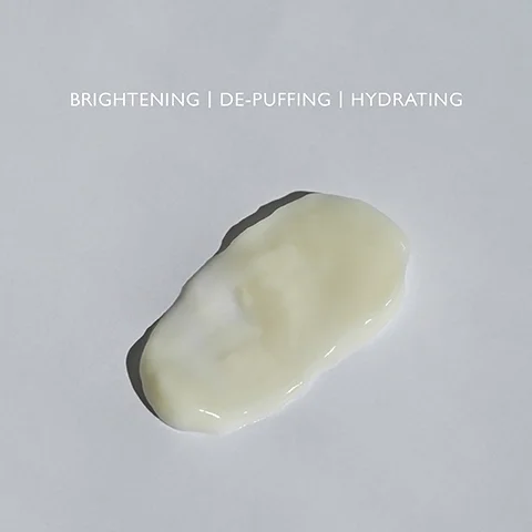 Product swatch on a grey background with the text BRIGHTENING, DE-PUFFING, HYDRATING.