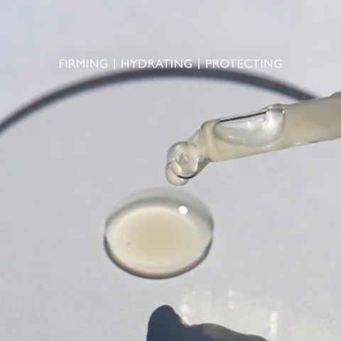 Product droplet on a clear palette with the text FIRMING, HYDRATING, PROTECTING.