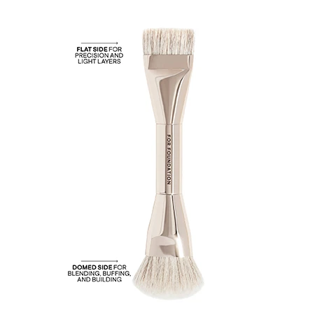 Image 2 - A shiny metallic double-ended makeup brush with light-colored bristles is displayed vertically on a white background, featuring a flat end for precision and light layers, a domed end for blending, buffing, and building, and the words FOR FOUNDATION written on its handle. Image 3 - A dual-ended makeup brush with light bristles is displayed beside a square bottle of amber-colored liquid foundation, with text on the brush stating FOR FOUNDATION, an arrow pointing to the bottle with text USE WITH MAJOR SKIN HYDRA-LUXE FOUNDATION, and text on the bottle reading PATRICK TA MAJOR SKIN™ HYDRA-LUXE LUMINOUS SKIN PERFECTING FOUNDATION.