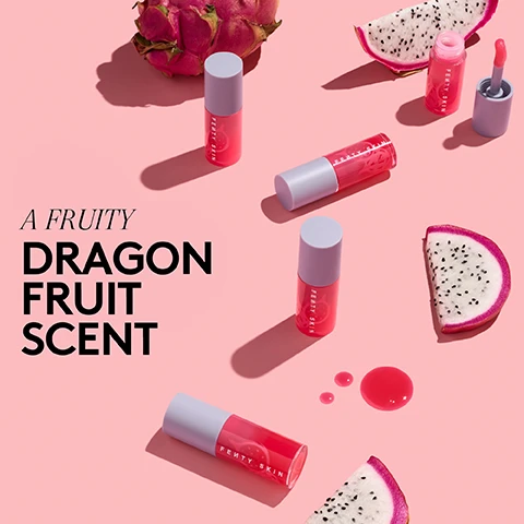 Image 1 - An arrangement of Fenty Skin products in pink packaging with a dragon fruit, both whole and sliced, on a pink backdrop, with the text A FRUITY DRAGON FRUIT SCENT.
Image 2 - Image shows a lab glass beaker filled with pink liquid, a pink lip product labeled FENTY SKIN, and a sliced dragon fruit, with text that reads MADE WITH, DRAGON FRUIT SEED OIL nourishes + conditions, DRAGON FRUIT EXTRACT hydrates + strengthens moisture barrier, and JOJOBA SEED + ROSEHIP FRUIT OILS help lock in moisture + soothe dry lips.