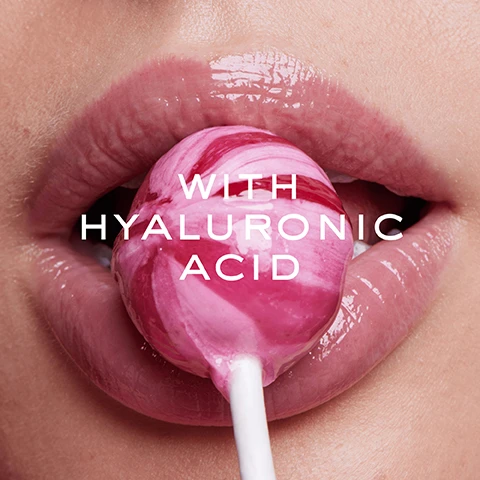 Image 1 - A close-up image of a womans lips holding a pink and white swirl lollipop, with the text on the image reading WITH HYALURONIC ACID.
Image 2 - A close-up image of a persons mouth holding an ice cube between their lips, with the text COOL TINGLING SENSATION ON THE LIPS overlaid in bold font.
Image 3 - Close-up of lips showing the difference between an untouched lip (before) and a glossy, enhanced lip (after) with visible text BEFORE on the left and AFTER on the right.
