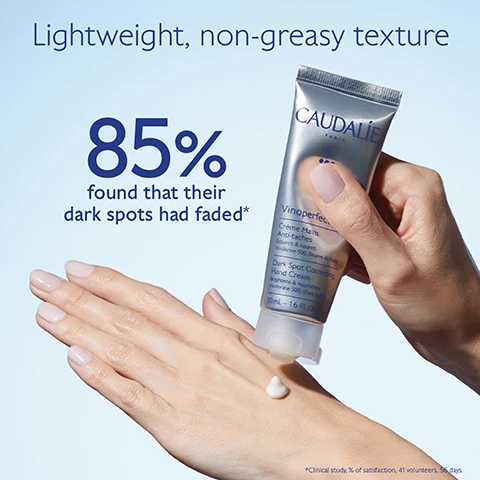 Image 1 - A hand is shown applying a white cream from a silver and blue tube labeled CAUDALIE Vinoperfect Dark Spot Correcting Hand Cream, with the text Lightweight, non-greasy texture and 85% found that their dark spots had faded* displayed above.
Image 2 - A tube of skincare cream is positioned with a dollop of cream coming out of the opening, surrounded by dark purple berries, with text stating White peony brightens and evens skin texture, Viniferine 62x more effective than vitamin C corrects and prevents dark spots, and Avocado oil nourishes without greasy effect.
Image 3 - Image shows two hand creams side by side: on the left, Vinoperfect Hand Cream with text that reads Anti-dark spots, Nourishes and protects, Enriched in Viniferine, and on the right, Vinotherapist™ Hand Cream with text that reads Repairing, Nourishes and protects, Enriched in Grape seed oil.
Image 4 - Image of a Vinoperfect hand cream tube from Caudalie, positioned at an angle with a cap next to it; the text on the image reads How to recycle Vinoperfect Hand Cream and Recycle the whole packaging (tube + cap) with Terracycle.