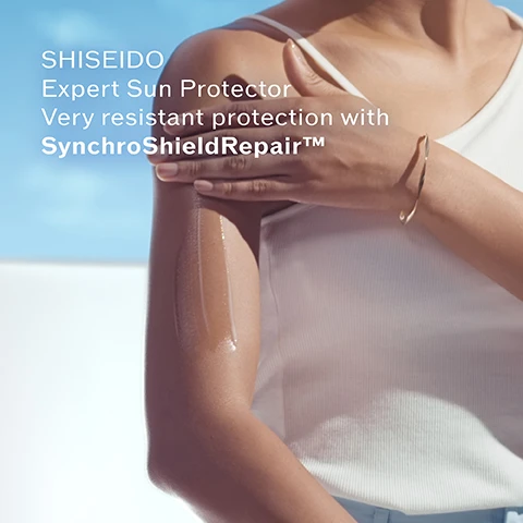Image 3 - A persons arm applying sun protection cream to their shoulder and forearm with streaks of the product visible on their skin, set against a bright blue sky and white wall, with the text SHISEIDO Expert Sun Protector Very resistant protection with SynchroShieldRepair™. Image 4 - A blue Shiseido Expert Sun Protector Lotion Lait Solaire bottle, labeled SPF 50+ UVA, VERY HIGH PROTECTION TRES HAUTE PROTECTION, and VERY WATER RESISTANT HAUTEMENT RESISTANT À LEAU, is presented alongside two petri dishes: one containing orange safflower plants with accompanying text Safflower Extract for beautified & plumped skin, and the other holding green algae with text Algae Complex for hydrated & smoothed skin. Image 5 - An image with a dark blue background with water droplets or bubbles, showing a vertical stack of three text boxes, each separated by a plus sign. The text on the image reads: NEW SynchroShieldRepair™. WetForce: Strengthens the protection veil in contact with water. HeatForce: Boosts the protection veil in hot weather. NEW AutoRepair: The protection veil repairs itself in case of friction. Image 6 - A dark blue Shiseido Expert Sun Protector Lotion Lait Solaire SPF 50+ UVA bottle with its reflection is displayed on a light blue background, with visible text reading 90% PLANT-DERIVED PLASTIC BOTTLE* *WITHOUT CAP, and the bottle itself states SHISEIDO Expert Sun Protector Lotion Lait Solaire SPF 50+ UVA VERY HIGH PROTECTION TRES HAUTE PROTECTION VERY WATER RESISTANT HAUTEMENT RESISTANT A LEAU.