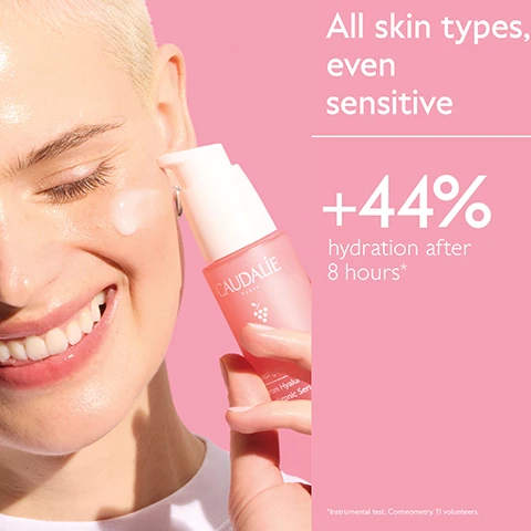 Image 1 - A smiling person with fair skin and short blonde hair has a drop of clear serum on their cheek, while holding a pink Caudalie VinoHydra serum bottle with a white pump against a pink background, with white text that reads All skin types, even sensitive, +44% hydration after 8 hours*, and *Instrumental test. Corneometry. 11 volunteers. Image 2 - A before and after image showing a womans face, with the left side labeled Before displaying skin with some texture and the right side labeled After displaying smoother, more radiant, and hydrated skin, with a pink bottle of Caudalie Hyaluronic Serum visible in the bottom right corner. The image includes the text Before, After, +44% hydration after 8 hours*, *Instrumental test. Corneometry. 11 volunteers., Unretouched results 8 hours after using Hyaluronic Serum., and on the bottle CAUDALIE PARIS VinoHydra Sérum Hyaluronique Hyaluronic Serum. Image 3 - A smiling woman with braided hair cleanses her face, covered in white foam, against a pink background, with text reading The cleanser for sensitive skin Soap-free Sulfate-free. Image 4 - A person with short blonde hair and clear skin applies a dab of white cream to their cheek from a pink tube, with visible text reading VinoHydra Crème Sorbet Hydratante Acide Hyaluronique Eau de Raisin Camomille Moisturizer Cream Hyaluronic Acid Grape Water Chamomile 60 mL - 2.0 FL.OZ. Normal skin, even sensitive 90% saw soothed skin* 70%* saw skin less prone to redness** *Clinical study. % of satisfaction. 22 volunteers. 28 days. **Redness due to skin dryness.
