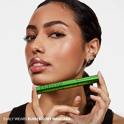 Image 1 - A woman with glossy lips and defined eyelashes holds a shiny green mascara tube horizontally under her chin, with visible text EMILY WEARS KUSH BIG HIT MASCARA. Image 2 - A grid displays six close-up photos of eyes, comparing KUSH Big Hit Mascara with BEFORE and AFTER columns and rows labeled Sparse Lashes, Straight Lashes, and Curly Lashes, illustrating the mascaras volumizing effect on each lash type. Image 3 - A green tube of Milk Kush Mascara with the black wand and brush extended, next to text describing the Big Hit Brush: Unique criss-cross bristles catch + coat every lash for max impact, Tapered tip easily defines inner corners + lower lashes, Big fluffy brush delivers full volume without clumps. Image 4 - A close-up of an eye with long, volumized eyelashes looking upwards, next to text that reads CLINICALLY PROVEN RESULTS 100% SAID LASHES HAVE HIGH VOLUME AND LOOK LONGER 100% SAID MASCARA IS BUILDABLE 93% SAID LASHES ARE FLAKE-FREE 90% SAID LASHES ARENT WEIGHED DOWN AND LOOK LIFTED *in a consumer perception study of 33 people immediately after using the product. Image 5 - A graphic displays a curved black textured surface, illustrating product benefits and ingredients in three white boxes with inset images, and reads: LASH-CARING INGREDIENTS. LIGHT-AS-AIR VOLUME. Cloud Fiber Tech puffs up lashes for weightless volume + lift. NOURISHES + STRENGTHENS. Hemp seed oil and murumuru seed butter help condition and fortify lashes. STAYS CLUMP-FREE. Vegan waxes provide creamy, buildable texture that doesnt flake or clump. Image 6 - A bright green tube of Milk Makeup mascara stands upright on a silver metallic circular surface, next to text that reads Max Out The Volume, Light-as-air volume with up to 12-hour wear, No clumping, smudging, flaking or drooping, Conditions + nourishes lashes, Ophthalmologist tested + safe for sensitive eyes, and Clean. Vegan. Cruelty-Free. Image 7 - Close-up of an eye with long, volumized eyelashes and a defined eyebrow, with text reading A BIG HIT OF LIGHT-AS-AIR VOLUME. Image 8 - A promotional image for the Kush Collection shows a silver-grey Kush High Roll Tubing Mascara with its wand and a green Kush Big Hit Volumizing Mascara with its wand, featuring the text: THE KUSH COLLECTION CLEAN. VEGAN. CRUELTY-FREE. SAFE FOR SENSITIVE EYES. OPHTHAMOLOGIST-TESTED. 1 KUSH HIGH ROLL TUBING MASCARA Lengthen + define up to 24 hours Water-resistant, smudge-proof tubing technology Flexible, tapered brush separates lashes for maximum definition 2 KUSH BIG HIT VOLUMIZING MASCARA Volumize + lift up to 12 hours No smudging, clumping, flaking or drooping Crisscross bristles coat lashes with weightless volumizing fibers. Image 9 - Close-up of a person with dark skin, showing their right eye with long eyelashes, a shiny cheek, a glossy reddish-brown lip, and an ear with a silver ear cuff and beaded hoop earring, with the text FEYI WEARS KUSH BIG HIT MASCARA.