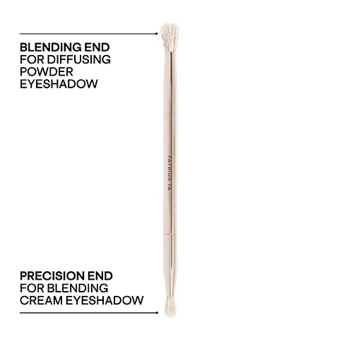 A double-ended rose gold makeup brush is shown vertically with a large fluffy blending end at the top and a small precise blending end at the bottom, labeled PATRICK TA on the handle, BLENDING END FOR DIFFUSING POWDER EYESHADOW pointing to the top end, and PRECISION END FOR BLENDING CREAM EYESHADOW pointing to the bottom end.